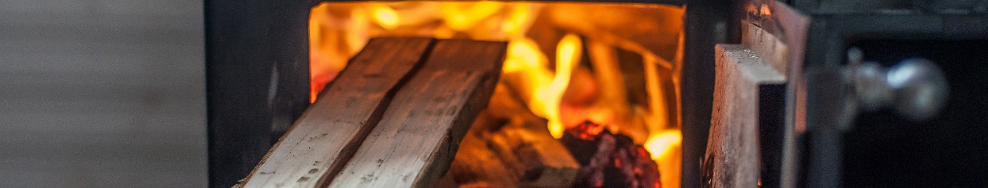 placing wood in wood stove