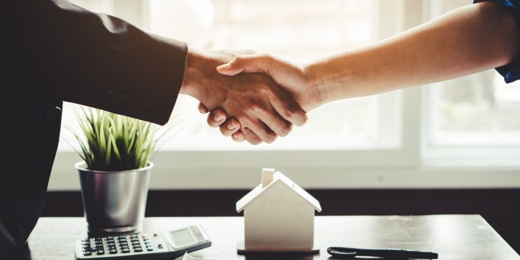 Landlord and tenant shaking hands after agreeing on renters insurance
