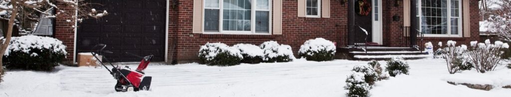house with snow in driveway