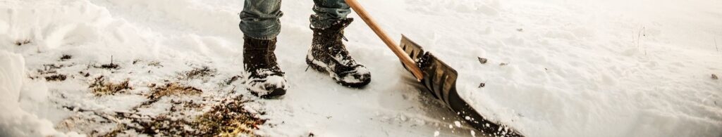 shoveling snow on sidewalk