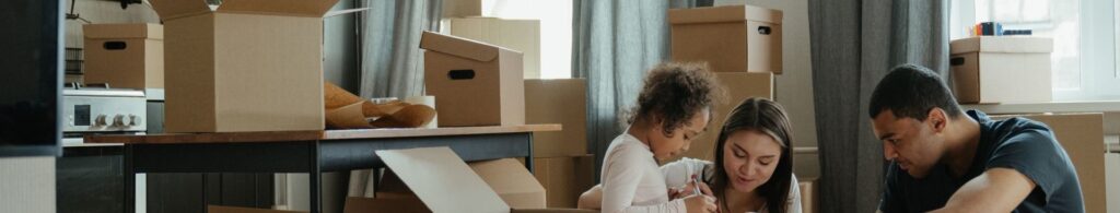 family packing moving boxes