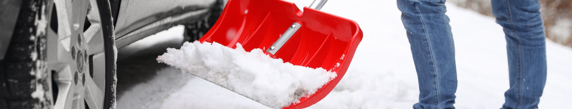 shoveling car out from snow