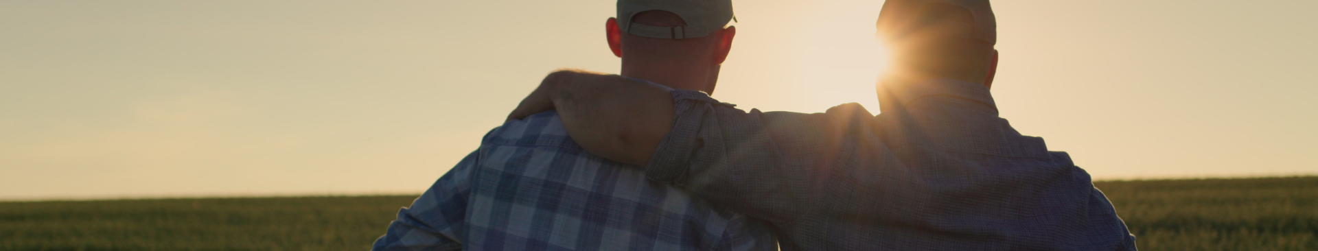 Image of elder farmer hugging son