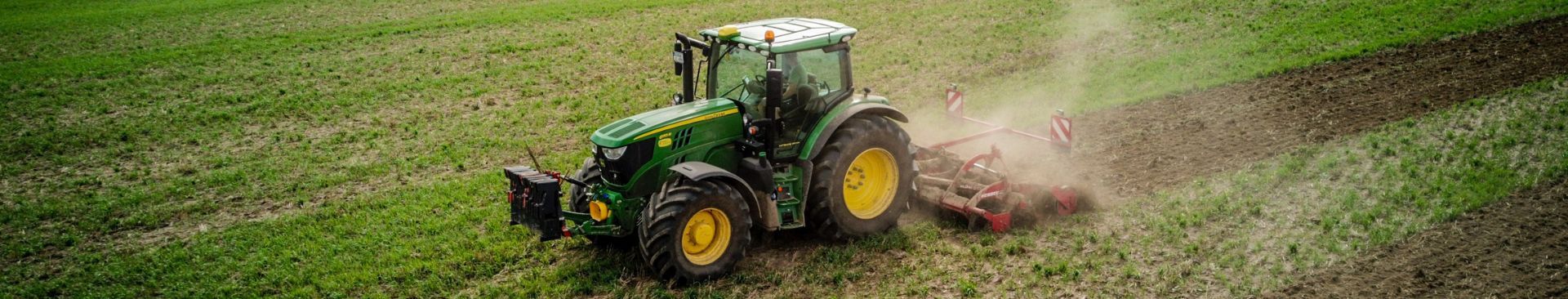 green tractor in farm field